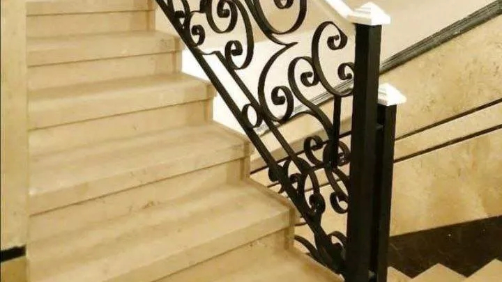 Metal staircase railing with handmade wrought iron flowers
