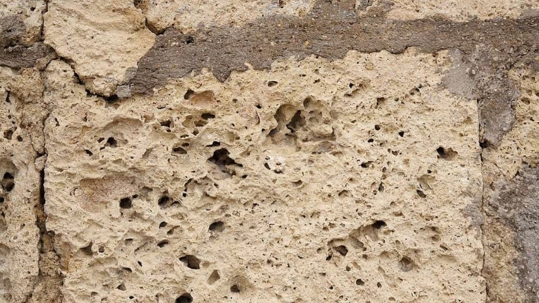 What kind of stone is travertine and how is it created?