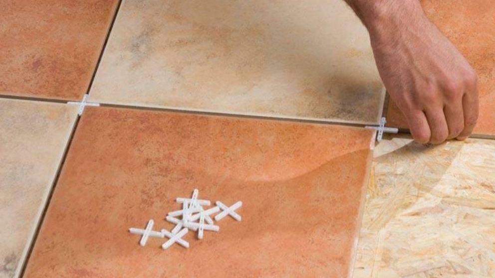 Why are tile spacers important in tiling?