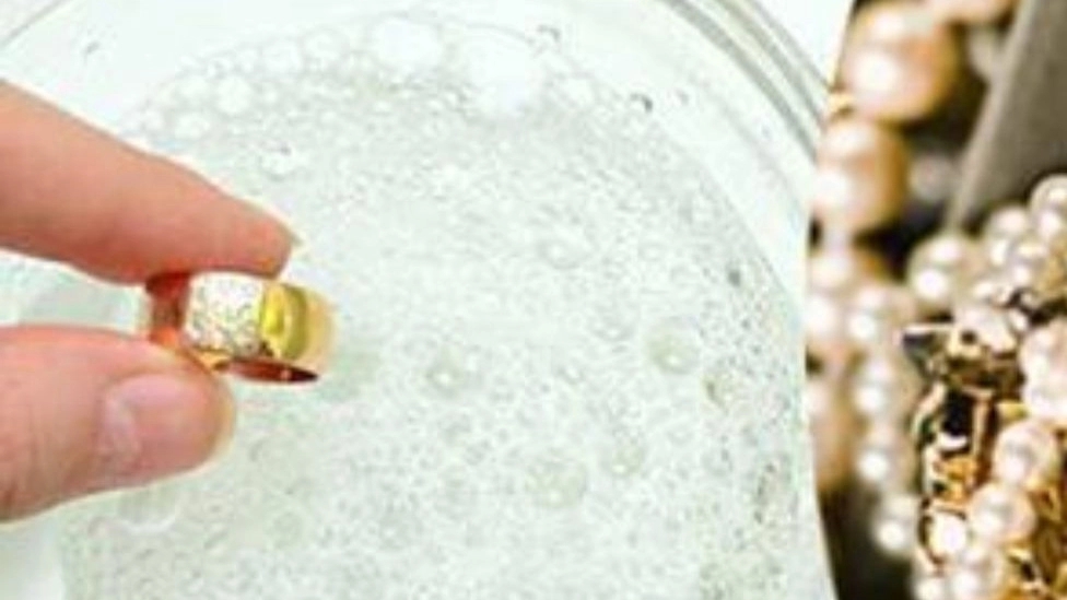 What materials should not be used to clean gold?