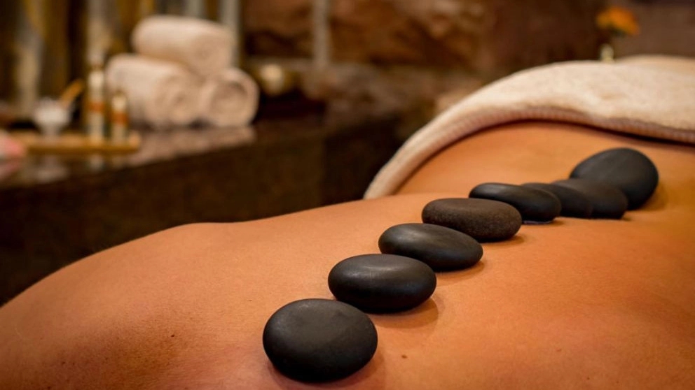 What is a massage stone and why is it used in massage?