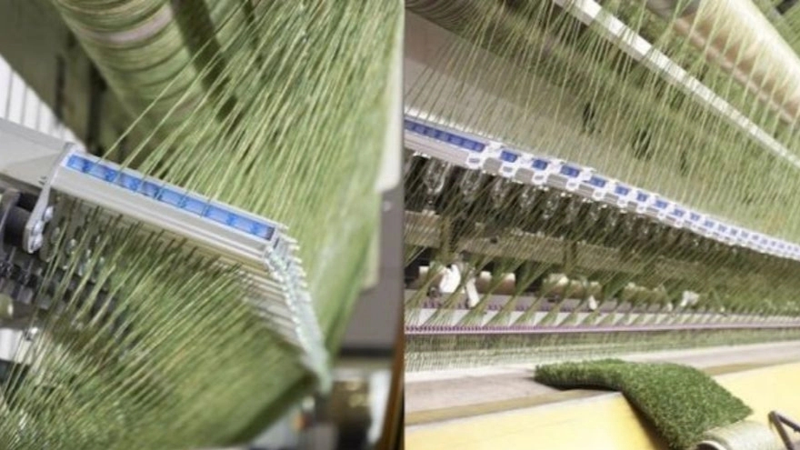 Artificial grass production machine