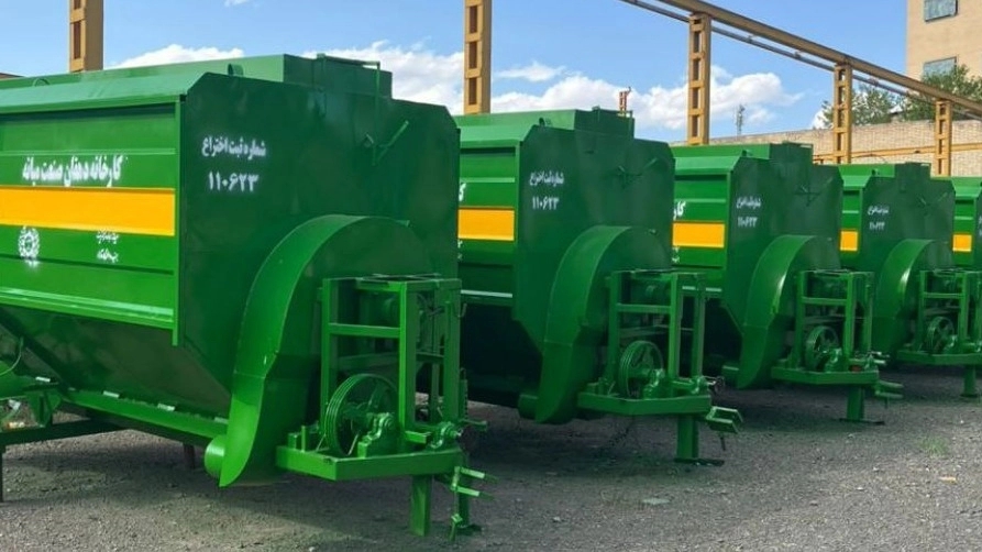 Strawing machine behind the tractor of the peasant industry in the middle of East Azerbaijan