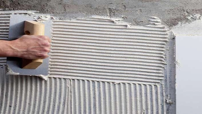 What is tile adhesive and what are its features and applications?