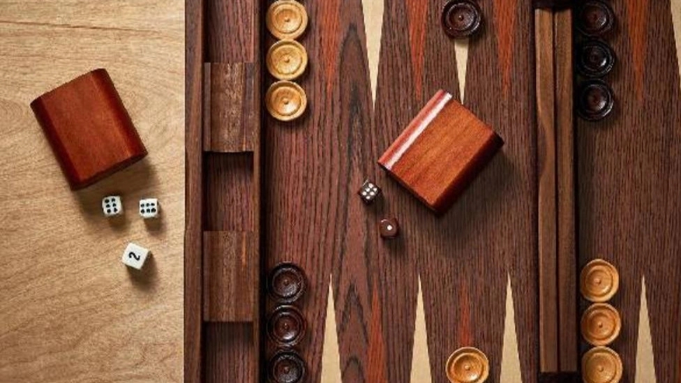 The history of backgammon dates back to which historical period?
