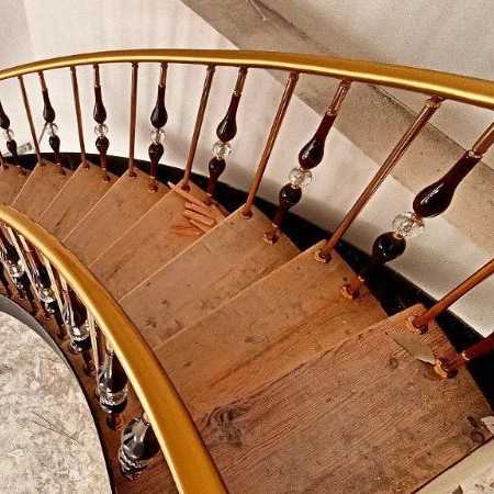 Wooden stairs for round stairs with steel fences