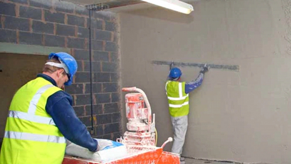 Removing plaster and soil from the building